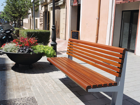 Moderne und stabil Parkbank aus Holz und Metall neben einem Pflanzkübel in der Stadt